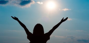 Excited woman enjoying wonderful sunlight